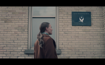 Handmaid's Tale S5Ep4 Serena in Front of Info Center with Sign